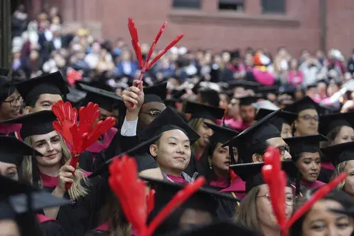 Harvard University students celebrate their graduate degrees in public health during Harvard commencement ceremonies, Thursday, May 25, 2023, in Cambridge, Mass. A pause on student loan payments that's been in place since the start of the COVID pandemic will end late this summer if Congress approves a debt ceiling and budget deal negotiated by House Speaker Kevin McCarthy and President Joe Biden. (AP Photo/Steven Senne, File)