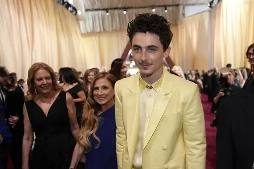 Nicole Flender, left, and Timothée Chalamet arrive at the Oscars on Sunday, March 2, 2025, at the Dolby Theatre in Los Angeles. (AP Photo/John Locher)
