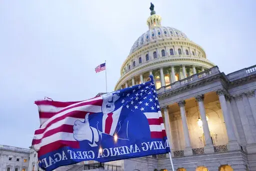 A flag depicting President Donald Trump flies on the East Front of the U.S. Capitol on Jan. 6, 2021, in Washington. (AP Photo/Manuel Balce Ceneta)