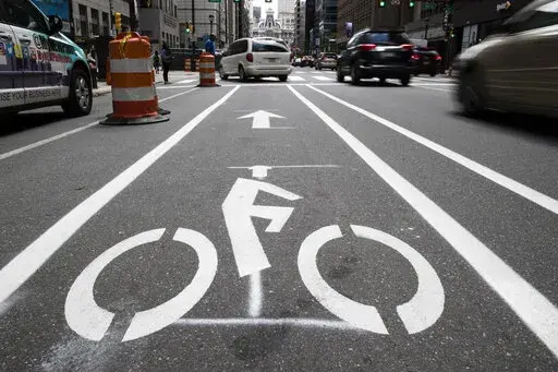 A bicycle lane along Market Street in Philadelphia, on June 4, 2018. The government has a fresh warning to states seeking billions of dollars from President Joe Biden's infrastructure law to widen roads: protect the safety of pedestrians and bicyclists or risk losing funds. In a new report submitted to Congress, the Transportation Department says it will now aim to prioritize the safety and health of all the users of a roadway, not just cars. (AP Photo/Matt Rourke, File)