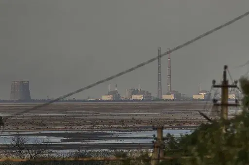 The Zaporizhzhia nuclear power plant, Europe's largest, is seen in the background of the shallow Kakhovka Reservoir after the dam collapse, in Energodar, Russian-occupied Ukraine, Tuesday, June 27, 2023. Officials at the Russian-controlled Zaporizhzhia Nuclear Power Plant said that the site was attacked Sunday April 7, 2024, by Ukrainian military drones, including a strike on the dome of the plant’s sixth power unit. (AP Photo/Libkos, File)