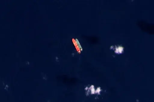 In this satellite photo provided by Planet Labs PBC, vessels identified as the Virgo, left, and the Suez Rajan, by the advocacy group United Against Nuclear Iran, are seen in the South China Sea on Feb. 13, 2022. A Greek shipper has pleaded guilty to a charge over it smuggling sanctioned Iranian crude oil and agreed to pay a $2.4 million fine, U.S. federal court papers seen Thursday, Sept. 7, 2023 by The Associated Press show. (Planet Labs PBC via AP, File)