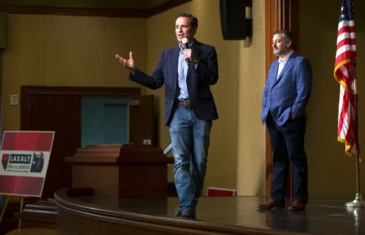 U.S. Sen. Ted Cruz, R-Texas, right, listens as Republican Nevada Senate candidate Adam Laxalt speaks during a Laxalt campaign event at Sun City Anthem Center in Henderson, Nev., Friday, April 22, 2022. Republicans are hoping that capturing a U.S. Senate seat in Nevada in November will give them control of the U.S. Senate. The front-runner for their nomination is Adam Laxalt, a former one-term attorney general and a staunch conservative who's embraced President Donald Trump's election lies. (Stev