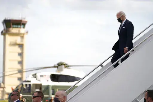 U.S. President Joe Biden, right, disembarks from Air Force One on his arrival at Yokota Air Base, Sunday, May 22, 2022, in Fussa, on the outskirt of Tokyo, Japan. (AP Photo/Evan Vucci)