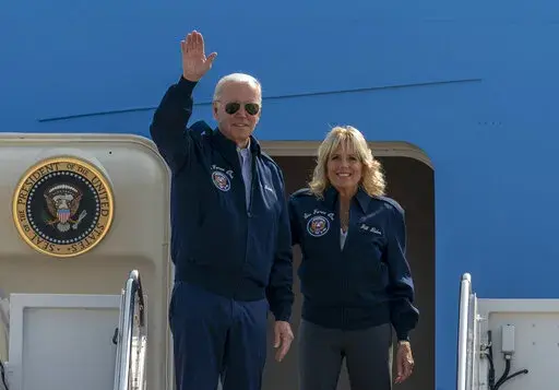 U.S. President Joe Biden waves as first lady Jill Biden watches standing at the top of the steps of Air Force One before boarding at Andrews Air Force Base, Md., Saturday, Sept. 17, 2022. President Biden said during and interview broadcasted on Sunday, Sept. 18, 2022, that U.S. forces would defend Taiwan if China tries to invade the self-ruled island claimed by Beijing as part of its territory, adding to displays of official American support for the island democracy in the face of Chinese intimi
