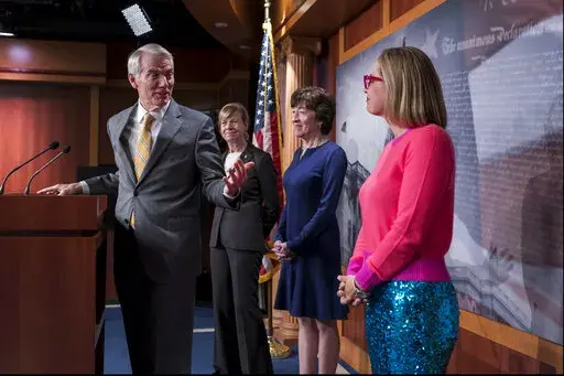 From left, Sen. Rob Portman, R-Ohio, Sen. Tammy Baldwin, D-Wis., Sen. Susan Collins, R-Maine, and Sen. Kyrsten Sinema, D-Ariz., talk with reporters following Senate passage of the Respect for Marriage Act, at the Capitol in Washington, Tuesday, Nov. 29, 2022. (AP Photo/J. Scott Applewhite)