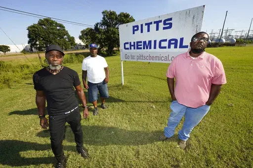 Richard Strong, left, his brother Gregory Strong, center, and Stacy Griffin pose for a photo on Sept. 9, 2021, in Indianola, Miss. They are among Black farmworkers in Mississippi who said in a lawsuit that their former employer, Pitts Farm Partnership, brought white laborers from South Africa to do the same jobs they were doing, and that the farm violated U.S. law by paying the white immigrants significantly more for the same type of work. The lawsuit and a similar one filed by other Black worke