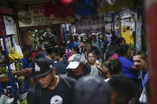 People shop at a street market in the Petare neighborhood of Caracas, Venezuela, Oct. 4, 2023. (AP Photo/Matias Delacroix, File)