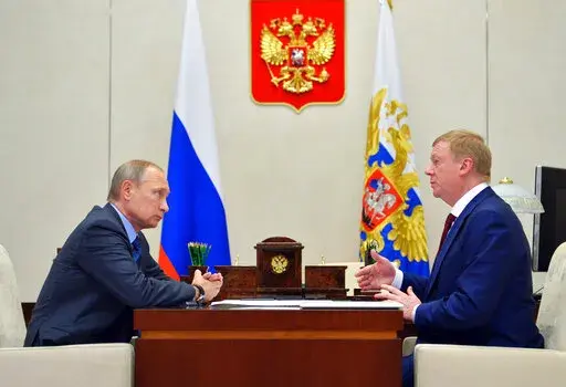 Russian President Vladimir Putin, left, listens to RUSNANO CEO Anatoly Chubais in the Novo-Ogaryovo residence, outside Moscow, Russia, Monday, Nov. 7, 2016. The resignation of Chubais, who was Putin's envoy to international organizations for sustainable development, was not the first resignation of a state official over the war with Ukraine, but it was one of the most striking. (AP Photo)