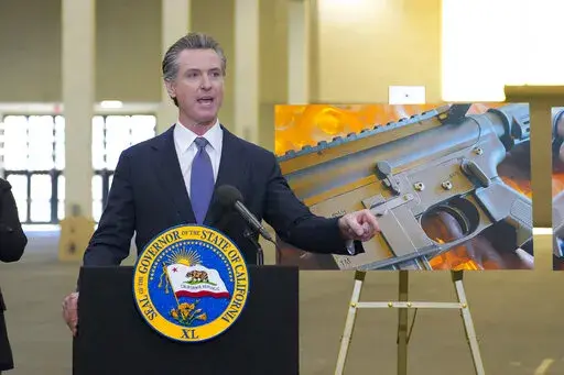 California Gov. Gavin Newsom along with several elected officials, met with the media at Del Mar Fairgrounds on Friday, Feb. 18, 2022, in Del Mar, Calif., where he backed state legislation that would allow for private citizens to enforce the state's ban on assault weapons. A new bill in California would allow private citizens go after gun makers in the same way Texas lets them target abortion providers, though gun advocates immediately promised a court challenge if it becomes law. (Nelvin C. Cep