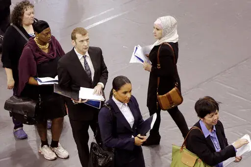 Job hunters line up for interviews at an employment fair sponsored by the New York State Department of Labor, Wednesday, Oct. 8, 2014 in the Brooklyn borough of New York. Just four months ago, city lawmakers overwhelmingly voted to require many ads for jobs in the nation's most populous city to include salary ranges, in the name of giving job applicants — particularly women and people of color — a better shot at fair pay. But on the cusp of implementing the measure, lawmakers voted Thursday 