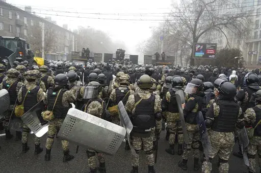 Riot police block a street to prevent demonstrators during a protest in Almaty, Kazakhstan, Wednesday, Jan. 5, 2022. Demonstrators denouncing the doubling of prices for liquefied gas have clashed with police in Kazakhstan's largest city and held protests in about a dozen other cities in the country. (AP Photo/Vladimir Tretyakov)