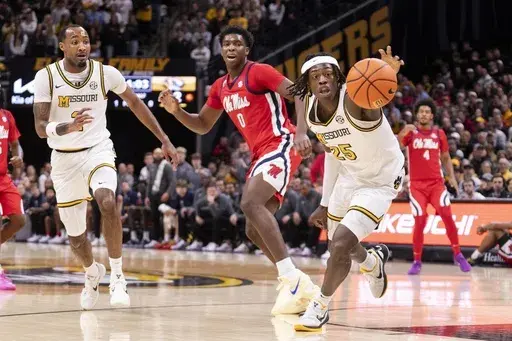 Missouri's Mark Mitchell, right, grabs a loose ball in front of Mississippi's Malik Dia (0) and Tamar Bates, left, during the first half of an NCAA college basketball game Saturday, Jan. 25, 2025, in Columbia, Mo. (AP Photo/L.G. Patterson)