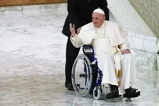 Pope Francis arrives in a wheelchair to attend an audience with nuns and religious superiors in the Paul VI Hall at The Vatican, Thursday, May 5, 2022. Pope Francis, whose mobility has been limited of late by a nagging knee problem, is looking forward to visiting South Sudan in July, according to a joint message by the pontiff, the archbishop of Canterbury and a Scottish church official. (AP Photo/Alessandra Tarantino, File)