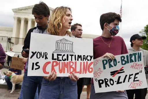 Demonstrators protest outside of the U.S. Supreme Court, Thursday, May 5, 2022, in Washington. A draft opinion suggests the U.S. Supreme Court could be poised to overturn the landmark 1973 Roe v. Wade case that legalized abortion nationwide, according to a Politico report released Monday. Whatever the outcome, the Politico report represents an extremely rare breach of the court's secretive deliberation process, and on a case of surpassing importance. (AP Photo/Mariam Zuhaib)