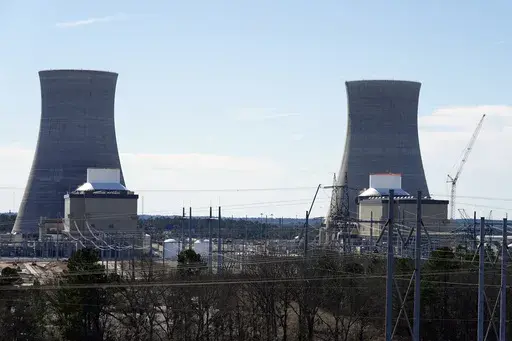 Units 3, left, and 4 and their cooling towers stand at Georgia Power Co.'s Plant Vogtle nuclear power plant, Jan. 20, 2023, in Waynesboro, Ga. Federal nuclear regulators announced on Friday, July 28, that they had cleared Georgia Power and its co-owners to load radioactive fuel into Unit 4, shown at right, the second of two new reactors on the site. (AP Photo/John Bazemore, File)