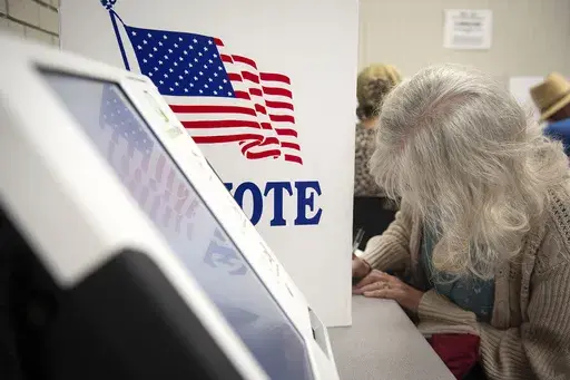 Voters fill in their ballots at at Precinct 5 at Wood Activity & Therapeutic Center in Clinton, Miss., during the general election, Nov. 7, 2023. The chairman of a congressional committee that has broad oversight of U.S. federal elections says ballot shortages in Mississippi's largest county could undermine voting and election confidence in 2024 if local officials don’t make changes. (Barbara Gauntt/The Clarion-Ledger via AP, file)