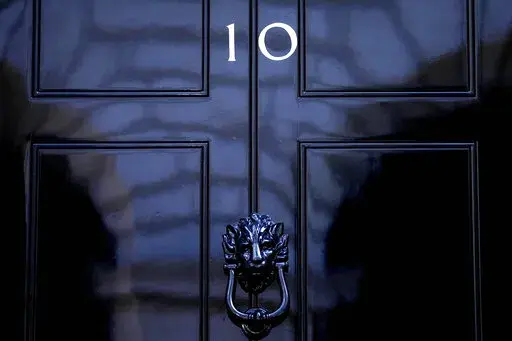 The door to 10 Downing Street in London, Friday, July 8, 2022. Under Britain's parliamentary system, the public never actually votes for its prime minister. Instead, voters tick the box for a representative from their local area, who then becomes one of Britain’s 650 Members of Parliament. The party that wins a majority forms a government and puts their leader into the prime minister's seat. (AP Photo/Frank Augstein, File)