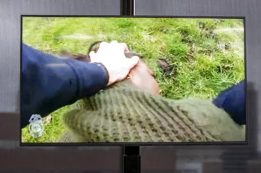 A TV display shows video evidence of a Grand Rapids police officer struggling with and shooting Patrick Lyoya at Grand Rapids City Hall on Wednesday, April 13, 2022. Lyoya, 26, was shot and killed about 8:10 a.m., on April 4, after what police said was a traffic stop. (Grand Rapids Police Department)