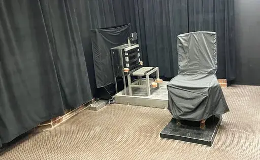 This photo provided by the South Carolina Dept. of Corrections shows the state’s death chamber in Columbia, S.C., including the electric chair, right,  and a firing squad chair, left. The agency renovated its capital punishment facility to include a metal chair with restraints facing a wall with a rectangular opening several feet away after South Carolina lawmakers added the firing squad to the state’s execution methods in 2021. ( South Carolina Dept. of Corrections via AP)