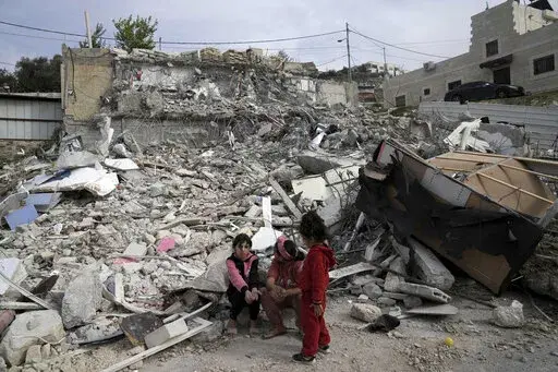 Girls from the Matar family sit near the rubble of their home that housed 11 people before it was demolished by Israeli authorities in the Jabal Mukaber neighborhood of east Jerusalem, Sunday, Jan. 29, 2023. For many Palestinians, the accelerating pace of home demolitions is part of Israel's new ultranationalist government's broader battle for control of east Jerusalem, claimed by the Palestinians as the capital of their future state. Israel says it is simply enforcing building regulations. (AP 