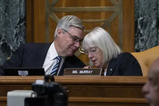 Senate Budget Committee Chairman Sheldon Whitehouse, D-R.I., confers with Sen. Patty Murray, D-Wash., right, during a hearing on the Republican proposal to address the debt limit which passed along party lines in the House last week, at the Capitol in Washington, Thursday, May 4, 2023. Senate Democrats are looking to pressure Republicans into resolving the impasse on the debt ceiling. (AP Photo/J. Scott Applewhite)