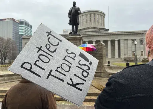 Protesters advocating for transgender rights and healthcare stand outside of the Ohio Statehouse, Jan. 24, 2024, in Columbus, Ohio. (AP Photo/Patrick Orsagost, File)