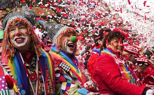 Revellers celebrate at the traditional Alter Markt the start of the street carnival in Cologne, Germany, Thursday, Feb. 16, 2023. Hundreds of thousands will celebrate the carnival without any coronavirus restrictions in the streets of the German carnival capital. (AP Photo/Martin Meissner)