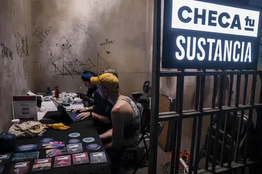 A man waits for his drug's lab results at the Check Your Substance booth that offers free drug testing, where people can confirm their drug does not contain adulterants or fentanyl, at a three-day electronic music festival in Mexico City, late Friday, Jan. 30, 2025. (AP Photo/Aurea Del Rosario)