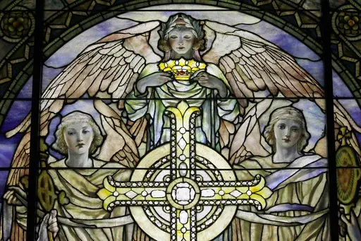 A detail of "The Righteous Shall Receive a Crown of Glory," Brainard Memorial Window for Methodist Church, Waterville, New York, ca. 1901 is photographed while on display at the "Louis C. Tiffany and the Art of Devotion" exhibit at the Museum of Biblical Art in New York on Thursday, Oct. 25 2012. About 7 in 10 U.S. adults say they believe in angels, according to a new poll released on Saturday, July 29, 2023, by The Associated Press-NORC Center for Public Affairs Research. (AP Photo/Mary Altaffe