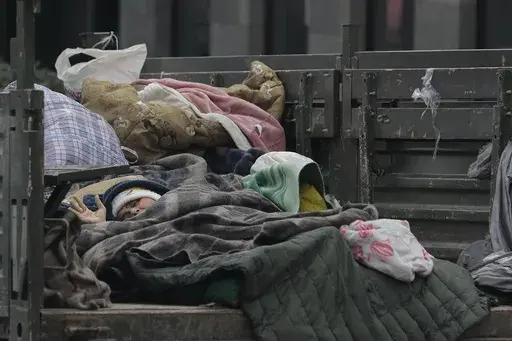 An ethnic Armenian woman from Nagorno-Karabakh rests in a truck as she arrives in Goris, Syunik region, Armenia, Wednesday, Sept. 27, 2023. Armenia finds itself facing multiple challenges after being suddenly thrust into one of the worst political crises in its decades of independence following the 1991 collapse of the Soviet Union. After Azerbaijan reclaimed control of the separatist region of Nagorno-Karabakh in a blitz offensive, tens of thousands of ethnic Armenians have flooded over its bor