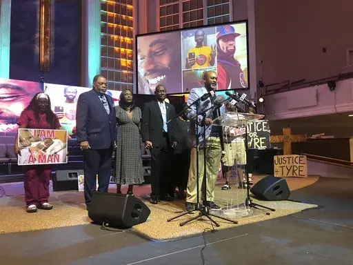 Tyre Nichols' stepfather Rodney Wells, second left, and Nichols' mother RowVaughn Wells, third left, close their eyes in prayer before a news conference about federal charges filed against five former officers in Nichols' death on Tuesday, Sept. 12, 2023, in Memphis, Tenn. Also pictured are attorney Ben Crump, fourth left, and pastor Earle Fisher, at lectern. AP Photo/Adrian Sainz)