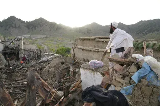A man stands among destruction after an earthquake in Gayan village, in Paktika province, Afghanistan, Thursday, June 23, 2022. A powerful earthquake struck a rugged, mountainous region of eastern Afghanistan early Wednesday, flattening stone and mud-brick homes in the country's deadliest quake in two decades, the state-run news agency reported. (AP Photo/Ebrahim Nooroozi)