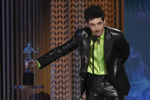 Timothee Chalamet accepts the award for outstanding performance by a male actor in a leading role for "A Complete Unknown" during the 31st annual Screen Actors Guild Awards on Sunday, Feb. 23, 2025, at the Shrine Auditorium in Los Angeles. (AP Photo/Chris Pizzello)