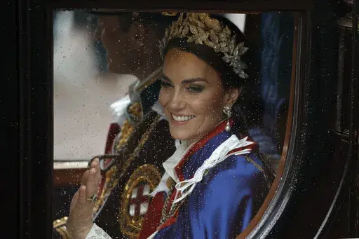 Kate, Princess of Wales and Prince William travel in a coach following the coronation ceremony of Britain's King Charles III in London, Saturday, May 6, 2023. (AP Photo/David Cliff, File)