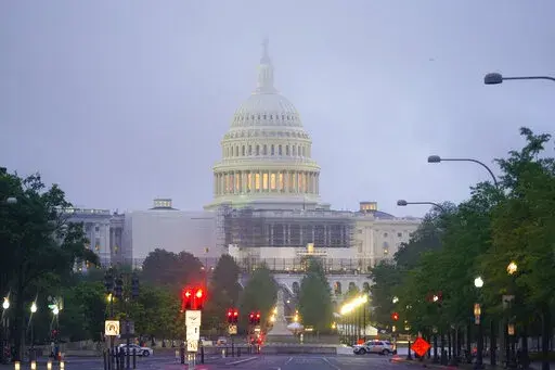 Morning fog begins to lift around the US Capitol in Washington, Saturday, May 14, 2022. (Photo/Pablo Martinez Monsivais)