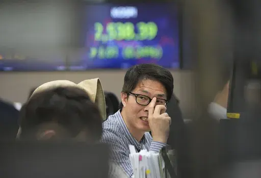 A currency trader works at the foreign exchange dealing room of the KEB Hana Bank headquarters in Seoul, South Korea, Monday, April 24, 2023. Asian stock markets were mixed Monday ahead of a U.S. economic update this week that is expected to show growth slowing. (AP Photo/Ahn Young-joon)
