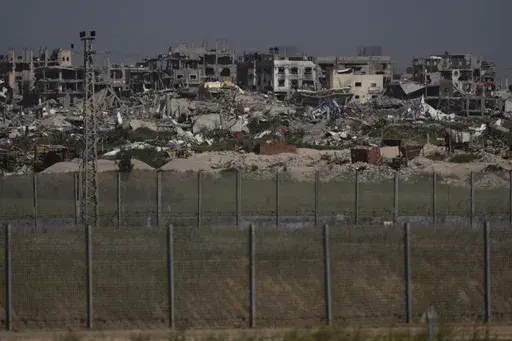 Destroyed buildings stand in the Gaza Strip as seen from southern Israel, Thursday, March 28, 2024. (AP Photo/Leo Correa)