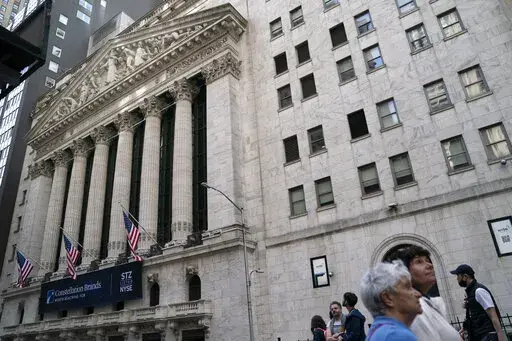 Pedestrians pass the New York Stock Exchange, May 5, 2022, in the Manhattan borough of New York. Stocks are off to a higher start on Wall Street Monday, June 6, 2022 led by more gains in big tech companies. The S&P 500 was up 0.8%. The benchmark index is coming off its eighth losing week in the last nine. The Nasdaq rose 1.2% and the Dow rose 0.5%. (AP Photo/John Minchillo, file)