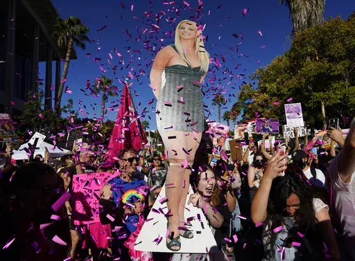 Britney Spears supporters celebrate following a hearing concerning the pop singer's conservatorship at the Stanley Mosk Courthouse, Friday, Nov. 12, 2021, in Los Angeles. California Gov. Gavin Newsom signed into law Friday, Sept. 30, 2022, legislation limiting conservatorships, a move that comes after Britney Spears' conservatorship case garnered national attention. (AP Photo/Chris Pizzello,File)
