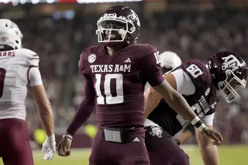 Texas A&M quarterback Marcel Reed (10) reacts after scoring a rushing touchdown against New Mexico State during the second half of an NCAA college football game Saturday, Nov. 16, 2024, in College Station, Texas. (AP Photo/Sam Craft)
