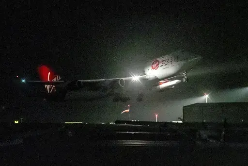 A repurposed Virgin Atlantic Boeing 747 aircraft, named Cosmic Girl, carrying Virgin Orbit's LauncherOne rocket, takes off from Spaceport Cornwall at Cornwall Airport, Newquay, England, on Jan. 9, 2023. Virgin Orbit said Thursday March 16, 2023 it is pausing all operations amid reports that the company is furloughing almost all its staff as part of a bid to seek a funding lifeline. (Ben Birchall/PA via AP)