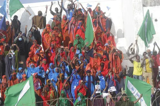 Residents and officials lead a demonstration supporting the government at Banadir stadium, Mogadishu, Thursday Jan. 12, 2023. The government rally encouraged an uprising against the al-Shabab group amid a month long military offensive. (AP Photo/Farah Abdi Warsameh)