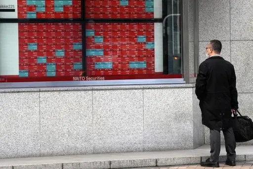 A person looks at an electronic stock board showing Japan's stock prices at a securities firm Friday, March 1, 2024, in Tokyo. Asian shares mostly rose Wednesday, March 13, encouraged by a record rally on Wall Street that was led by technology companies. (AP Photo/Eugene Hoshiko, File)
