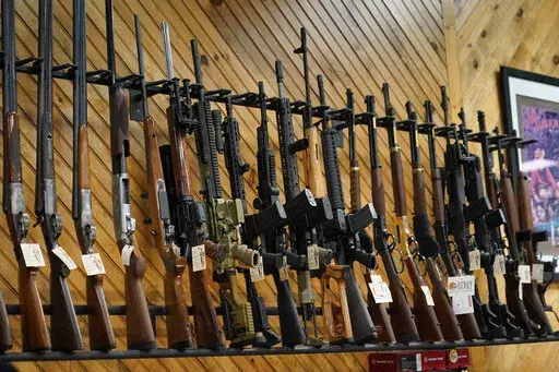 Various guns are displayed at a store on July 18, 2022, in Auburn, Maine. Most U.S. adults think gun violence is increasing nationwide and want to see gun laws made stricter. That's according to a new poll that finds broad public support for a variety of gun restrictions. The poll comes from the University of Chicago Harris School of Public Policy and The Associated Press-NORC Center for Public Affairs Research. (AP Photo/Robert F. Bukaty, File)