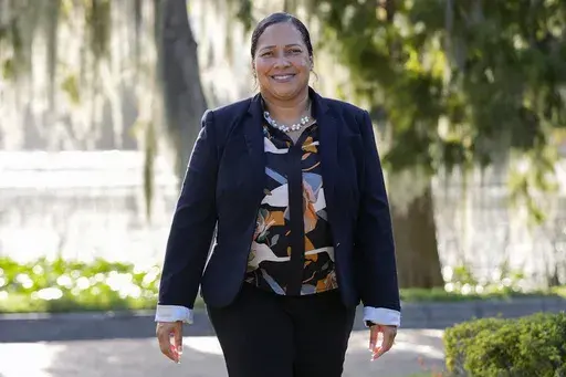 Marisol Ortega, a Polk County resident that commutes to her job in Orlando walks at a park Thursday, Nov. 14, 2024, in Orlando, Fla. (AP Photo/John Raoux)