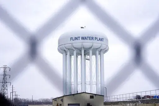 The Flint water plant tower is seen on Jan. 6, 2022, in Flint, Mich.  A Michigan judge dismissed charges Tuesday, Oct. 4, 2022,  against seven people in the Flint water scandal, including two former state health officials blamed for deaths from Legionnaires' disease. Judge Elizabeth Kelly took action three months after the Michigan Supreme Court said a one-judge grand jury had no authority to issue indictments. (AP Photo/Carlos Osorio, File)