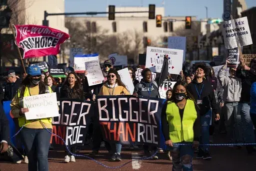 People march through downtown Amarillo to protest a lawsuit to ban the abortion drug mifepristone, Feb. 11, 2023, in Amarillo, Texas. Two years after the U.S. Supreme Court ended a nationwide right to abortion, travel and pills have become big parts of the issue.(AP Photo/Justin Rex, File)