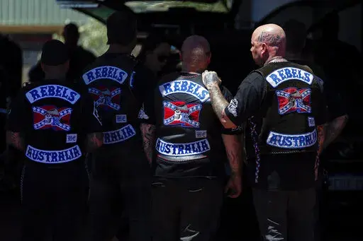 Mourners gather at a funeral parlor in north Perth, Australia before riding to the funeral of murdered Rebels biker Nick Martin at Pinnaroo Cemetery in Perth, Australia, on Wednesday, Dec. 23, 2020. The former Rebels president was gunned down earlier in the month at the Perth Motorplex. Martin’s murder left police a trove of evidence that led them to the culprit. But they wanted more. The coronavirus pandemic provided it in the form of an electronic dragnet: QR code check-in data from contact 