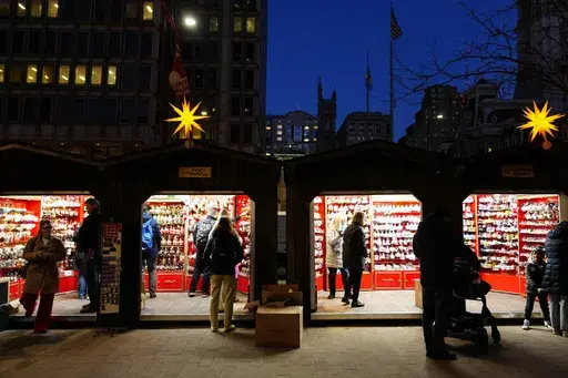 Shoppers visit the Christmas Village in Philadelphia, Wednesday, Dec. 13, 2023. Holiday sales rose in 2023 as spending remained resilient during the critical shopping season even as shoppers deal with still stubborn inflation in some areas as well as other financial worries, according to one measure. (AP Photo/Matt Rourke, File)